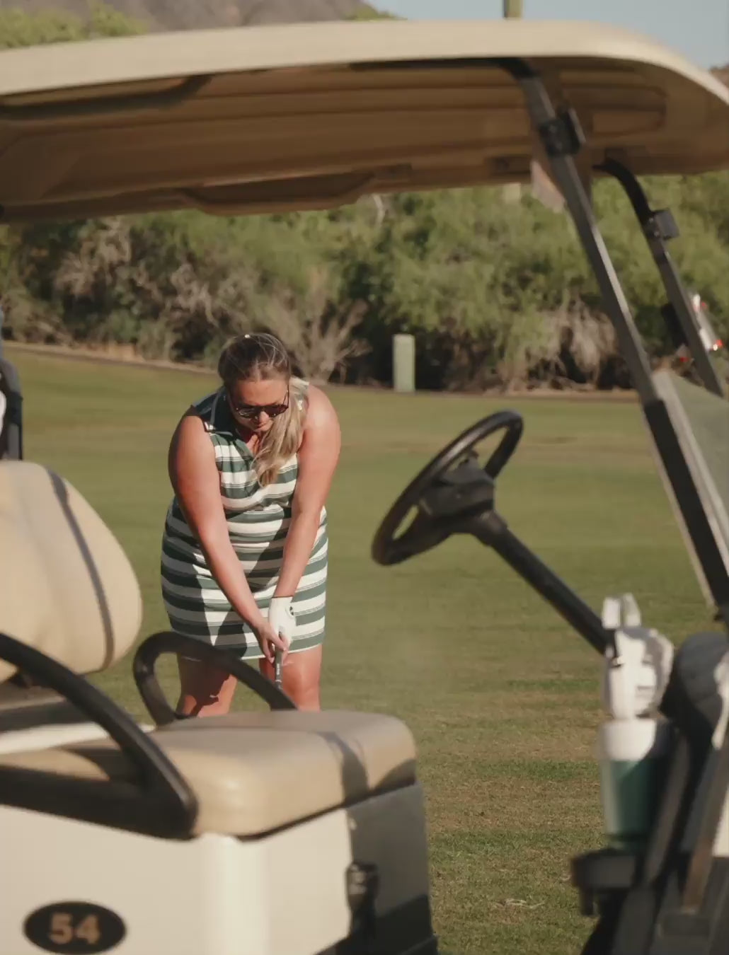 Load video: Golfer in dress in the sun